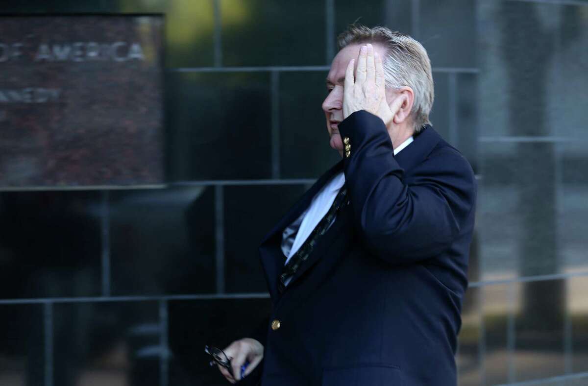 Steve Stockman covers his face while entering the United States District Courthouse Tuesday, March 21, 2017, in Houston.