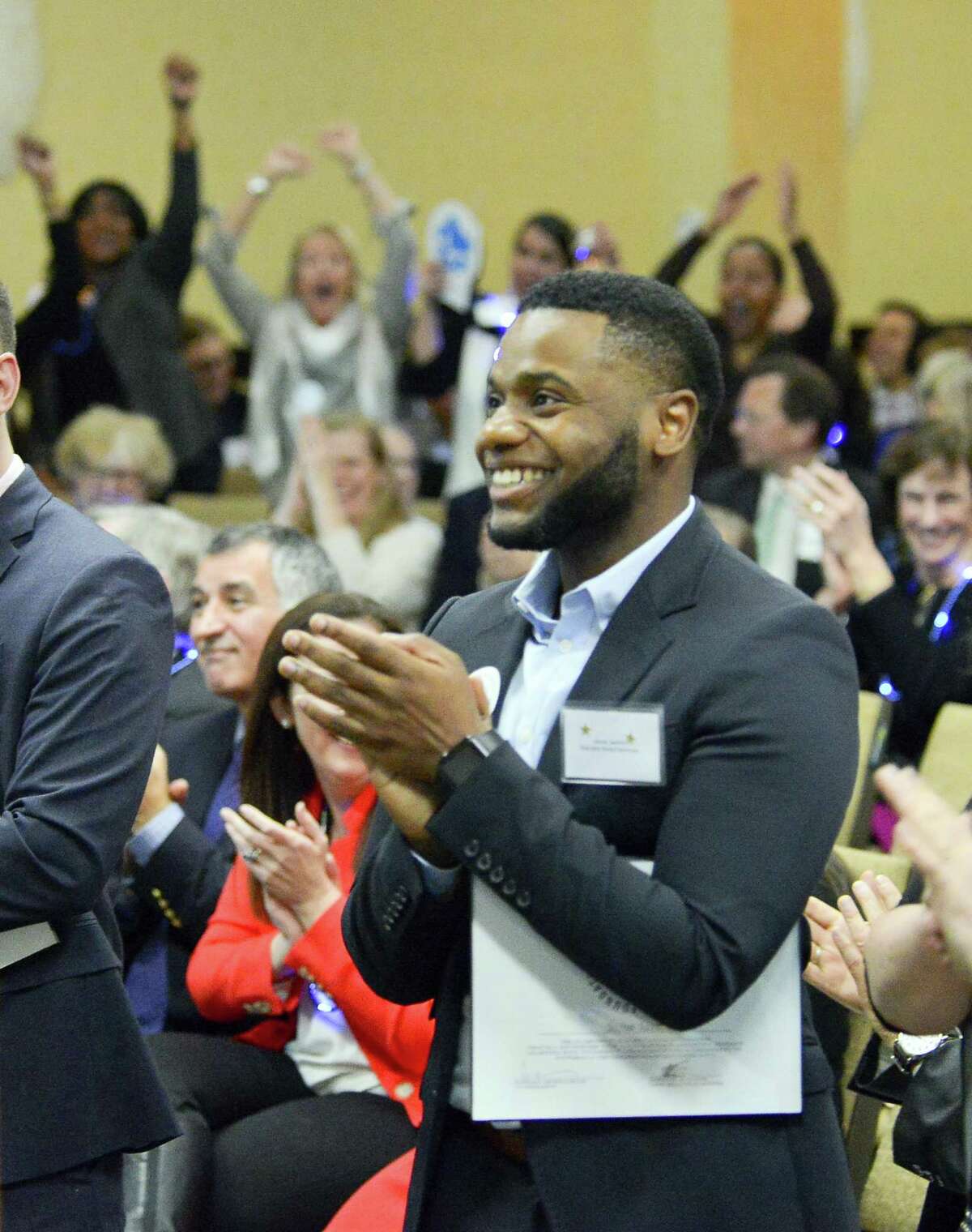Family and friends celebrate as Josue Jasmin of Rogers International School is named as co-Educator Award winner, along with Claude Morest of AITE during the Stamford Public Education Foundation 2017 Excellence in Education Awards ceremony at the Sheraton Stamford Hotel in Stamford, Conn. on March 23, 2017.