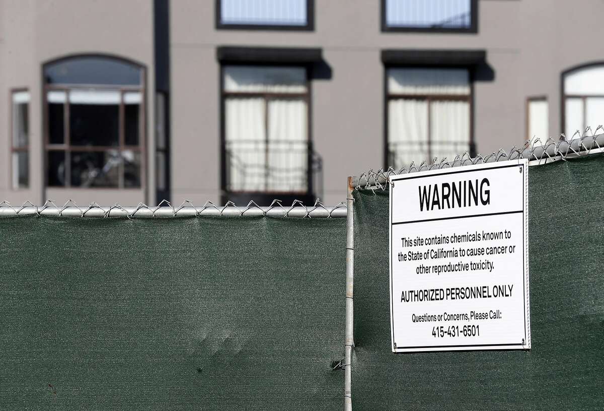 A condominium construction site at 1598 Bay Street displays a sign warning of hazardous material in the Marina District of San Francisco, Calif. on Thursday, March 23, 2017. PG&E has been quietly buying property on land the utility operated manufactured gas plants long ago which is still contaminated. PG&E excavated the hazardous soil, replaced it with clean dirt and resold the land.