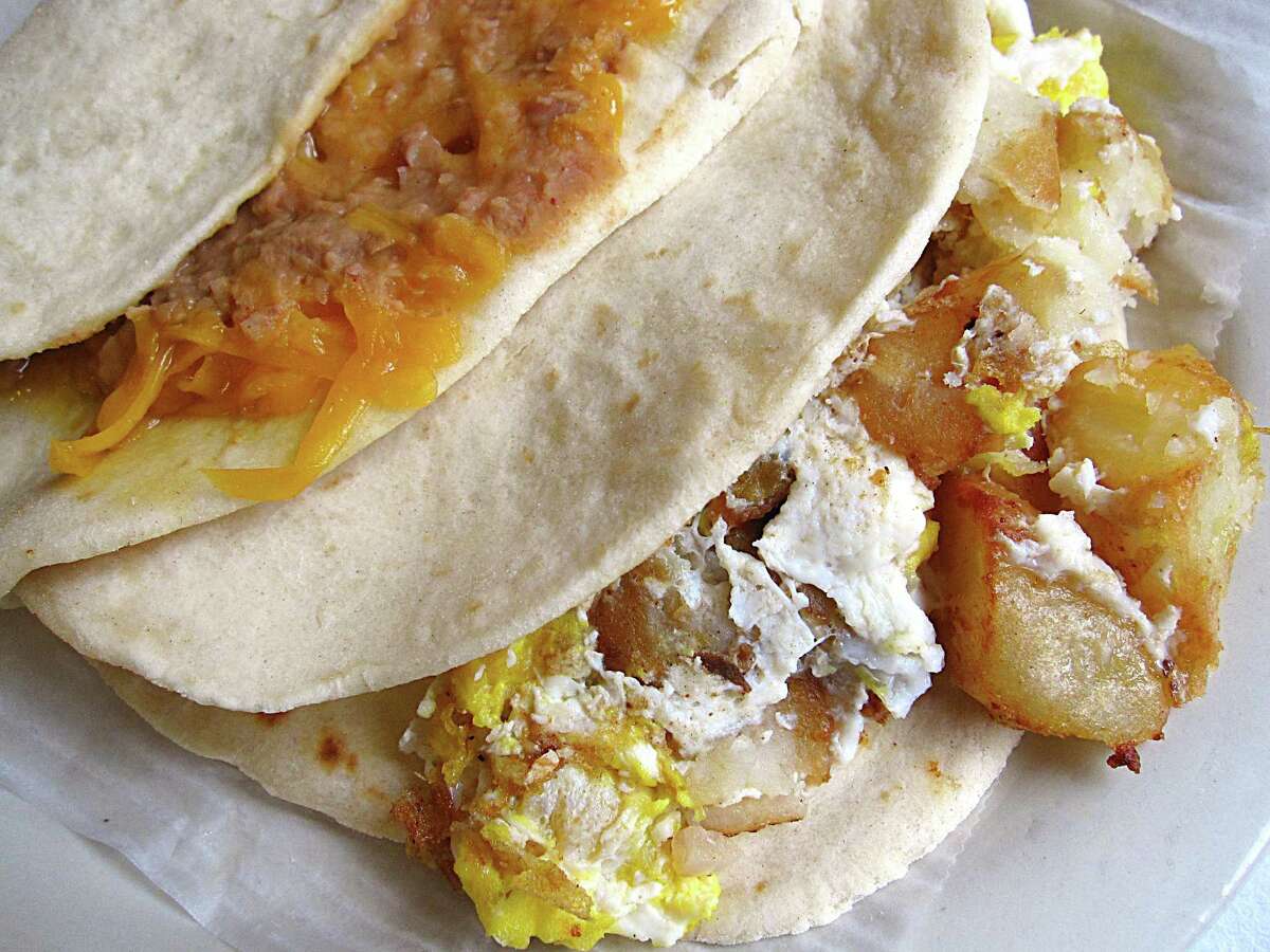 Bean and cheese, left, and potato and egg tacos on handmade flour tortillas from Taquería Arandas.