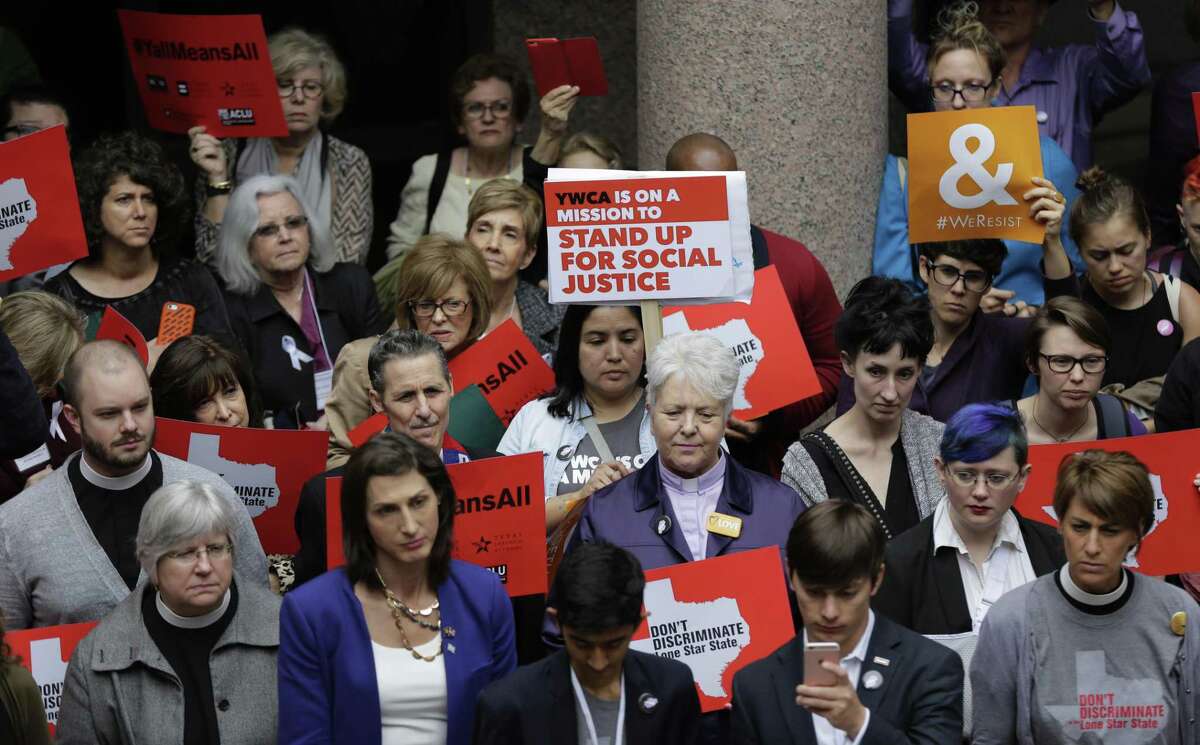 Members of the transgender community and others who oppose Senate Bill 6 protest in the exterior rotunda at the Texas Capitol as the Senate State Affairs Committee holds hearings on the bill, Tuesday, March 7, 2017, in Austin, Texas. The transgender "bathroom bill" would require people to use public bathrooms and restrooms that correspond with the sex on their birth certificate. (AP Photo/Eric Gay)
