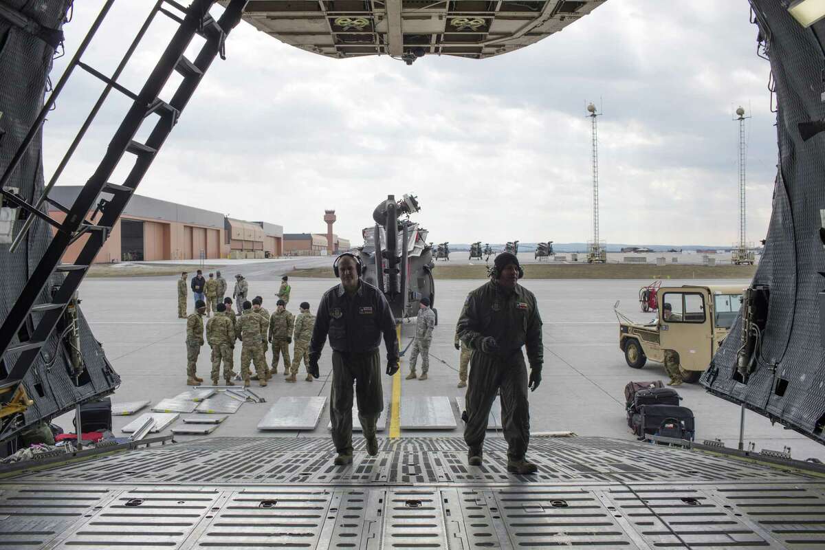 Air Force Reserve's Tech Sgt. Bryan Stone, left, and loadmaster Master Sgt. Eric Mungia prepare the cargo area a C-5M Super Galaxy at Fort Drum, New York, Monday, Feb. 27, 2017. The crew, with the 433rd Airlift Wing, known as the Alamo Wing, was tasked with transporting U.S. Army UH-60 Blackhawk helicopters and soldiers from the U.S. Army 10th Combat Aviation Brigade to Riga, Latvia in support of Operation Atlantic Resolve.