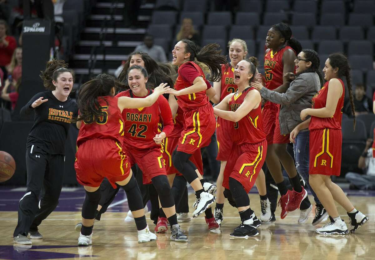 Rosary Academy players celebrate their 62-45 victory over Campolindo in their CIF Girls Division III high school state championship basketball game on Friday, March 24, 2017 in Sacramento, Calif.
