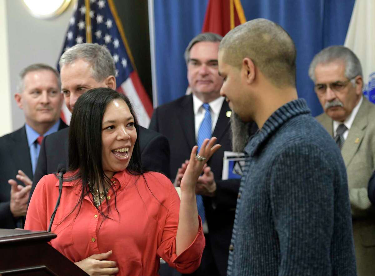 First-time homebuyer Saretha Sotomayor, left stands with her husband Luis as recipients at the announcement by Attorney General Eric Schneiderman of $20 million in grants to 19 land banks that uses the funds to rebuild neighborhoods across the State Friday March 24, 2017 in Albany, N.Y. (Skip Dickstein/Times Union)