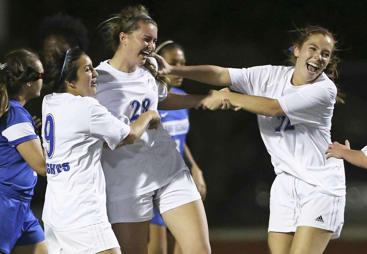 Mules players celebrate a goal with Katherine Detmer who deflected a corner kick into the net as Alamo Heights plays Richards at Orem Stadium in a class 5A bidistrict playoff on March 24, 2017.