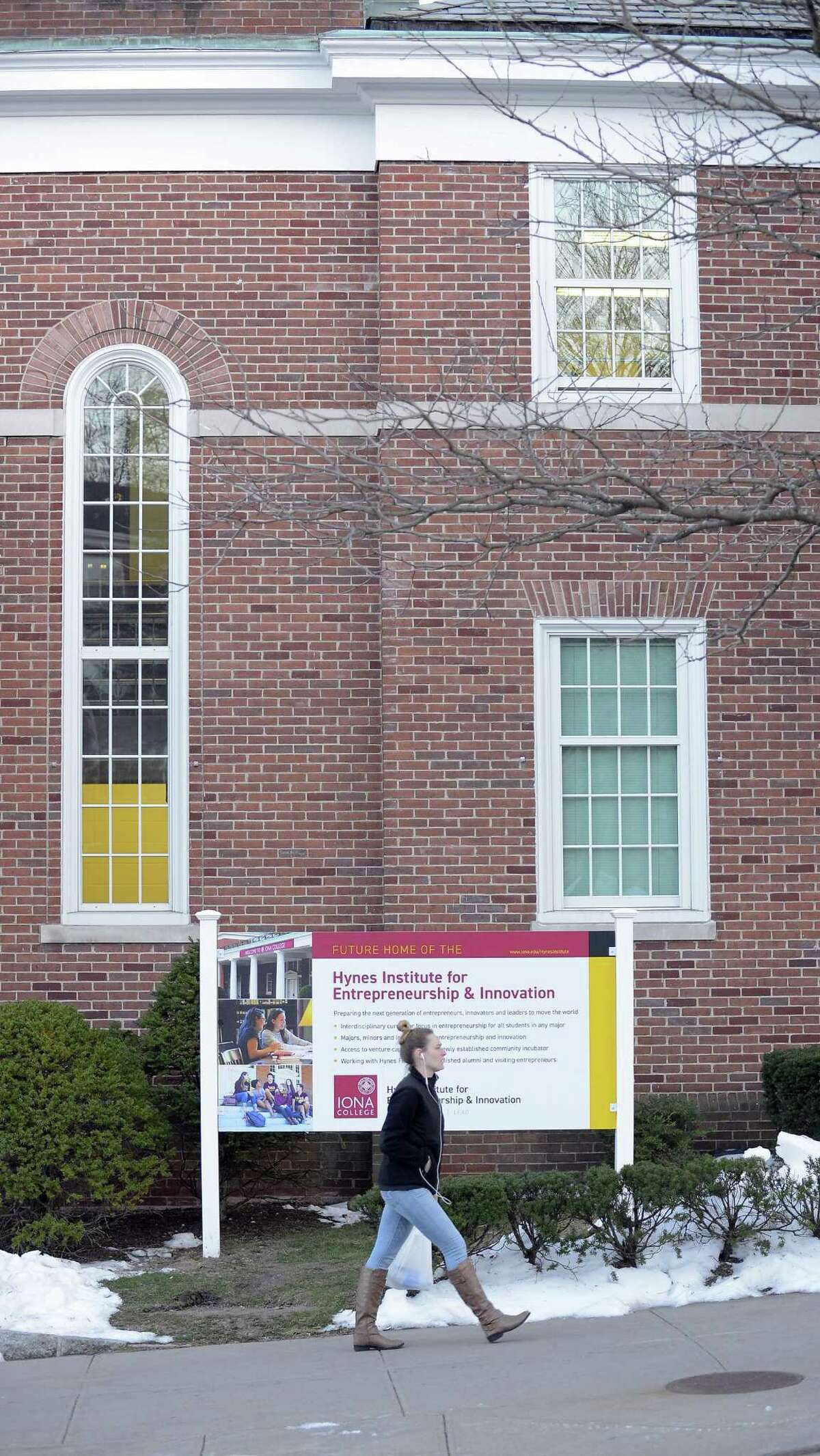 A student walks past Spellman Hall, the future home of the Hynes Institute at Iona College in New Rochelle, NY on March 21, 2017. James and Anne Marie Hynes of Greenwich donated $15 million to the school. James Hynes has very fond memories of his old alma mater, Iona College in New Rochelle, N.Y. Hynes parents were immigrants from Ireland, and he was the first of his family to graduate from college in 1969 from the college founded in 1940 by the Christian Brothers. His education there put him on the path toward a very successful career as an entrepreneur and telecommunications executive, with a residence along the shore in Greenwich.