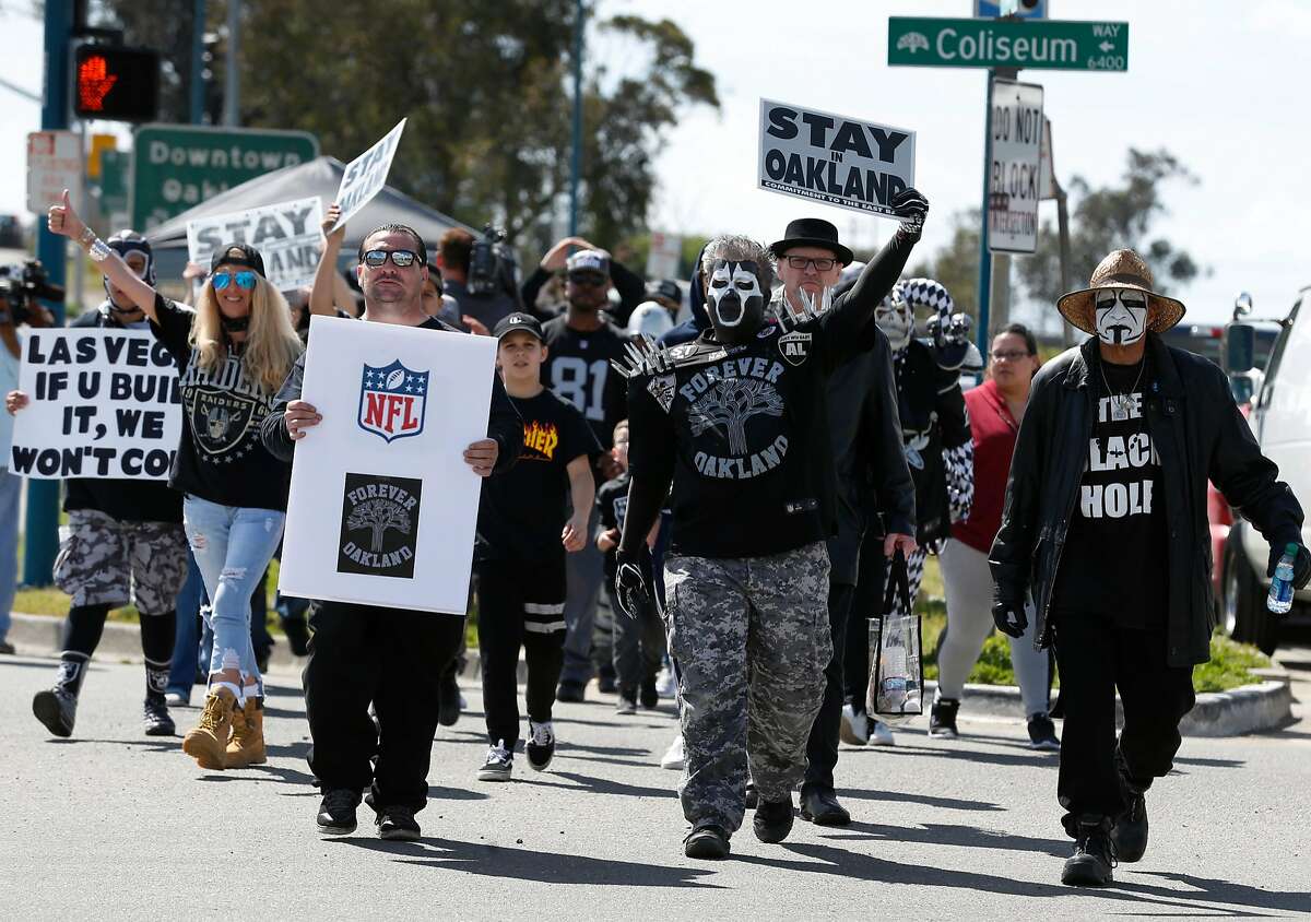About 50 dedicated Oakland Raiders fans begin a march on 66th Avenue past the Coliseum after Mayor Libby Schaaf provided details of a last minute stadium plan at a news conference in Oakland, Calif. on Saturday, March 25, 2017, hoping to convince NFL owners to reject a proposed relocation of the Raiders to Las Vegas.
