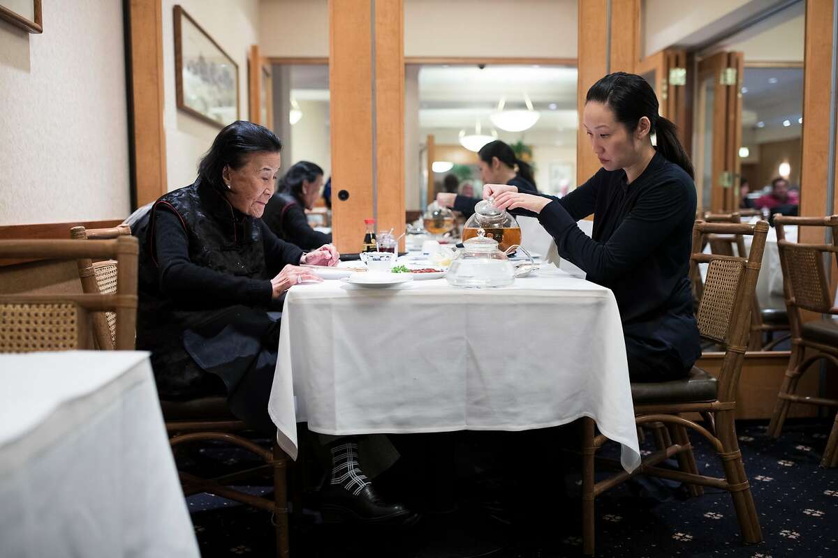 Vera Chan-Waller, right, owner of Yank Sing, pours tea while having lunch with restaurateur Cecilia Chiang in San Francisco, Calif. on Friday, March 24, 2017.