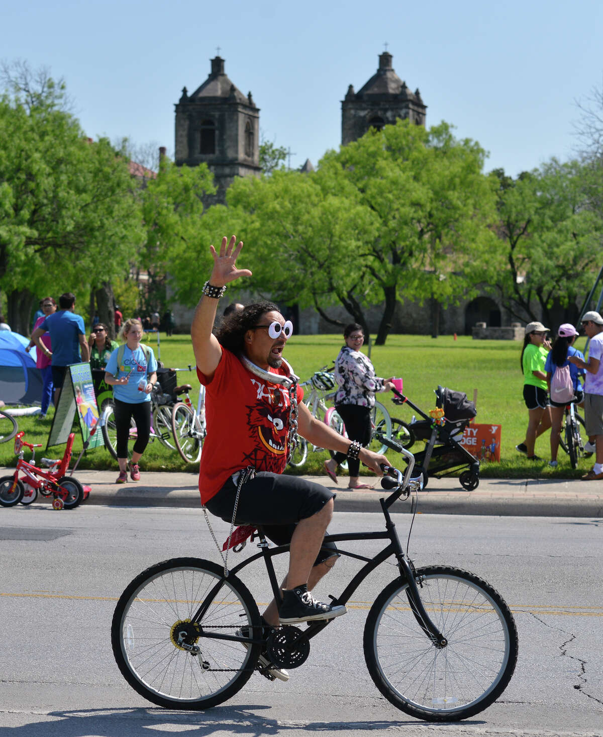 A cyclist rides past Mission Concepcion during the spring Siclovia Sunday. Streets from the downtown HEB store to the Mission were blocked off to all motorized traffic.