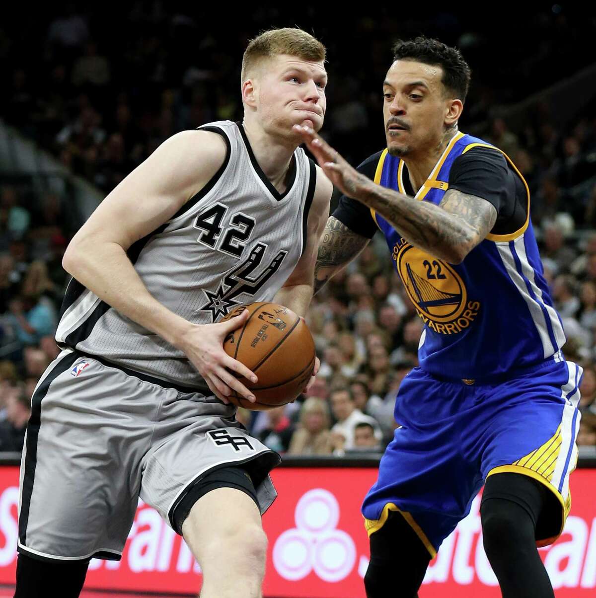 Spurs’ Davis Bertans looks for room around the Golden State Warriors’ Matt Barnes during second half action on March 11, 2017 at the AT&T Center.