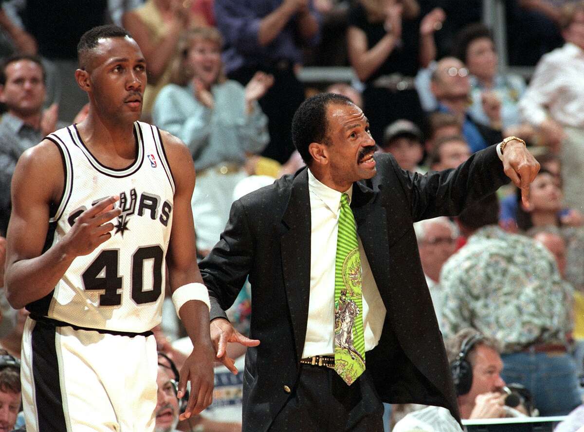 Spurs coach John Lucas, flanked by Willie Anderson, instructs his team during a playoff game against Portland in 2001.
