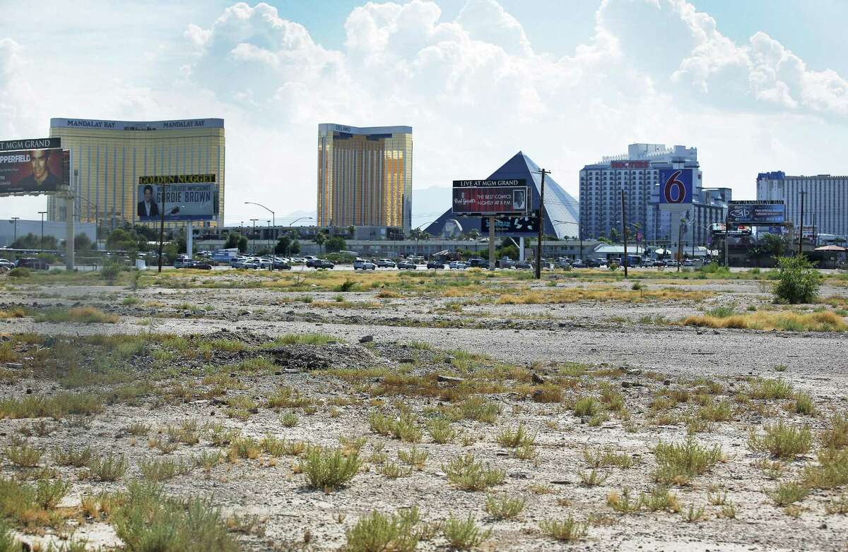 In this July 1, 2016, file photo, a vacant lot that is the site of a proposed football stadium sits near McCarran International Airport in Las Vegas. NFL owners approved the Oakland Raiders move to Las Vegas on March 27, 2017, at the league meetings.