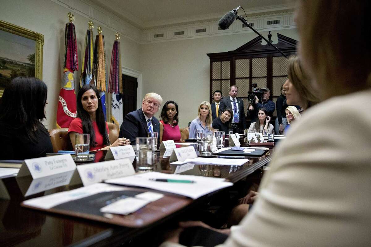 U.S. President Donald Trump and daughter Ivanka Trump (center) listen during a meeting with female small-business owners Monday in the Roosevelt Room of the White House.