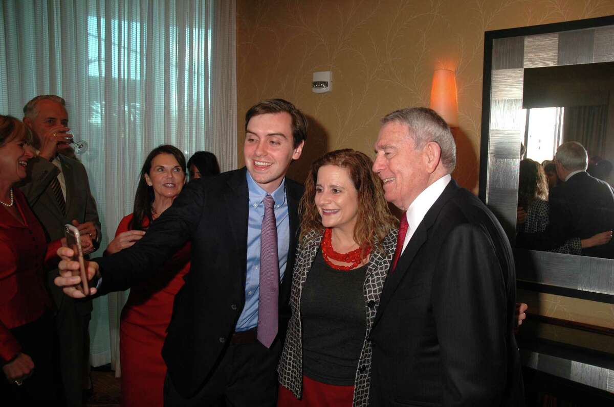 Dan Rather, right, and his grandson Martin Rather, left, meet with attendees at the Red Cross Texas Gulf Coast RegionÂ?’s Â?“Wrapped in RedÂ?” fundraiser at Hilton AmericaÂ?’s downtown.