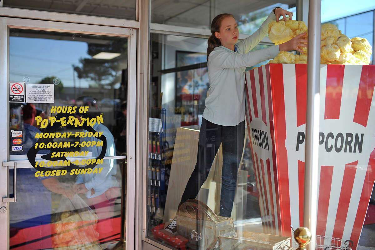 Popcorn Premiere will close Saturday.  File photo: Ryleigh Hamilton, an eighth grader at Midland Christian School, arranges giant popcorn pieces in a display at Popcorn Premiere on March 27, 2017. Hamilton and other students in Jena McClaine's art class built giant popcorn kernals as a class project to be displayed at Popcorn Premiere. The students delivered them on March 27, 2017. James Durbin/Reporter-Telegram