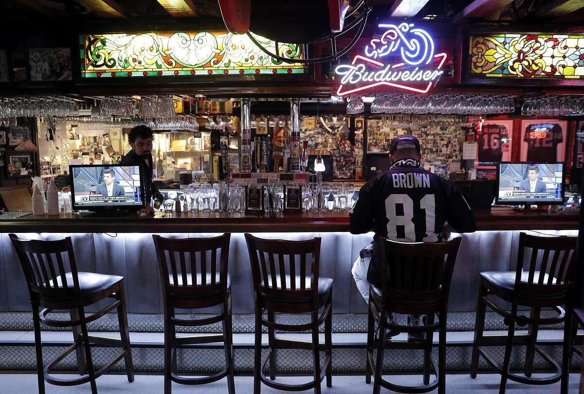 Justin Reina of Oakland sits alone at the bar at Ricky's Sports Theater and Grill following the news of the Raiders imminent departure in San Leandro, Calif., on Monday, March 27, 2017. The NFL announced that team owners had approved the Raiders' move to Las Vegas.