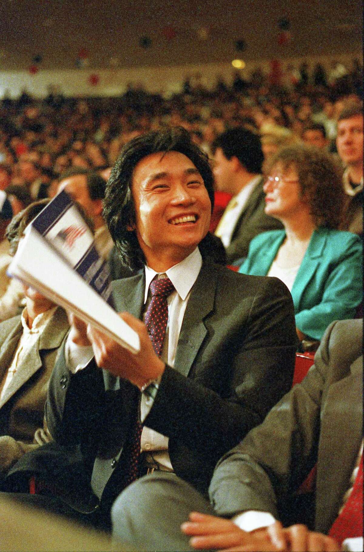 12/19/1986 - Houston Ballet dancer Li Cunxin is one of 4,200 Houston-area people sworn-in as American citizens at Hofheinz Pavilion in the largest-ever naturalization ceremony in Texas.