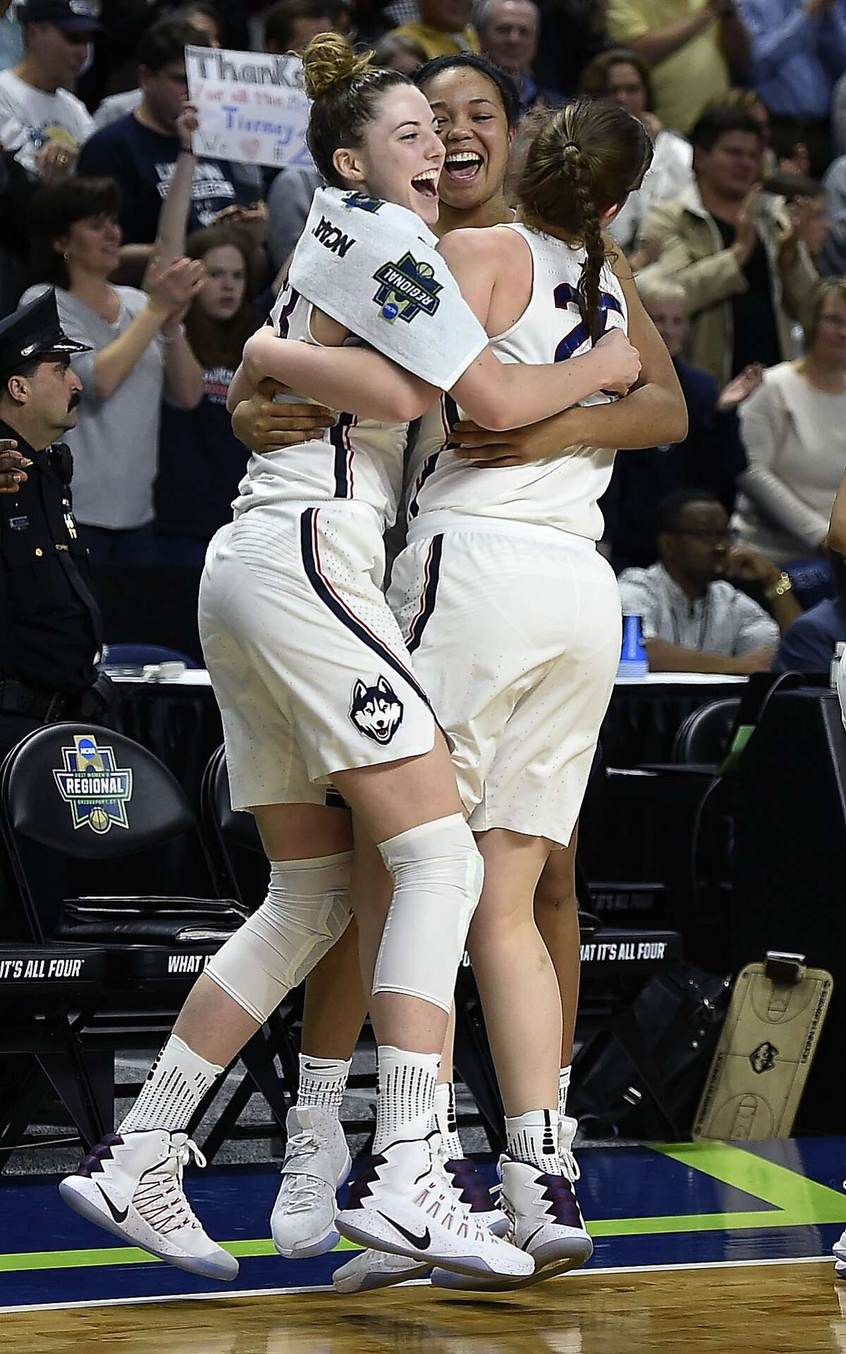 Connecticut's Katie Lou Samuelson, left, Napheesa Collier, center, and Kyla Irwin, right, celebrate as the clock winds down on their 90-52 win over Oregon in a regional final game in the NCAA women's college basketball tournament, Monday, March 27, 2017, in Bridgeport, Conn. (AP Photo/Jessica Hill)
