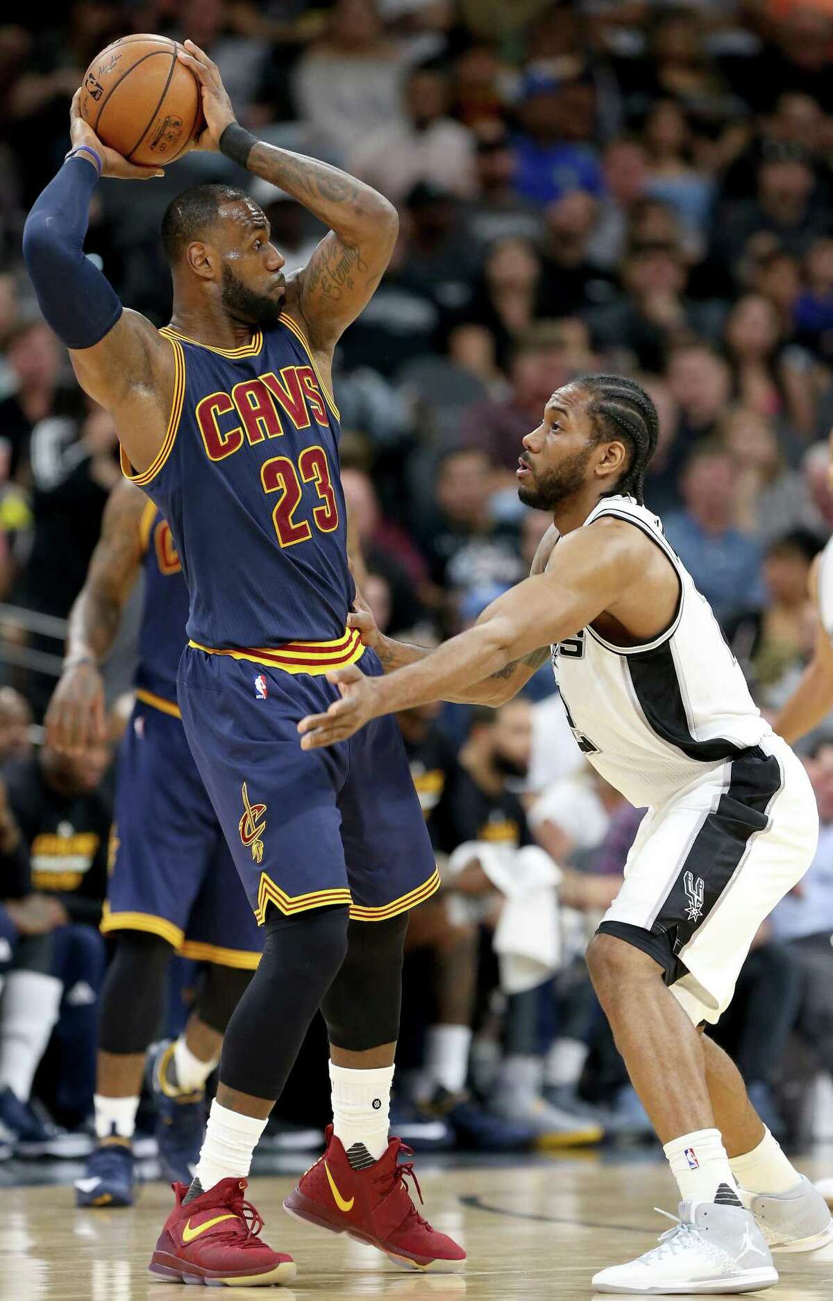 San Antonio Spurs' Kawhi Leonard defends Cleveland Cavaliers' LeBron James during first half action Monday March 27, 2017 at the AT&T Center.