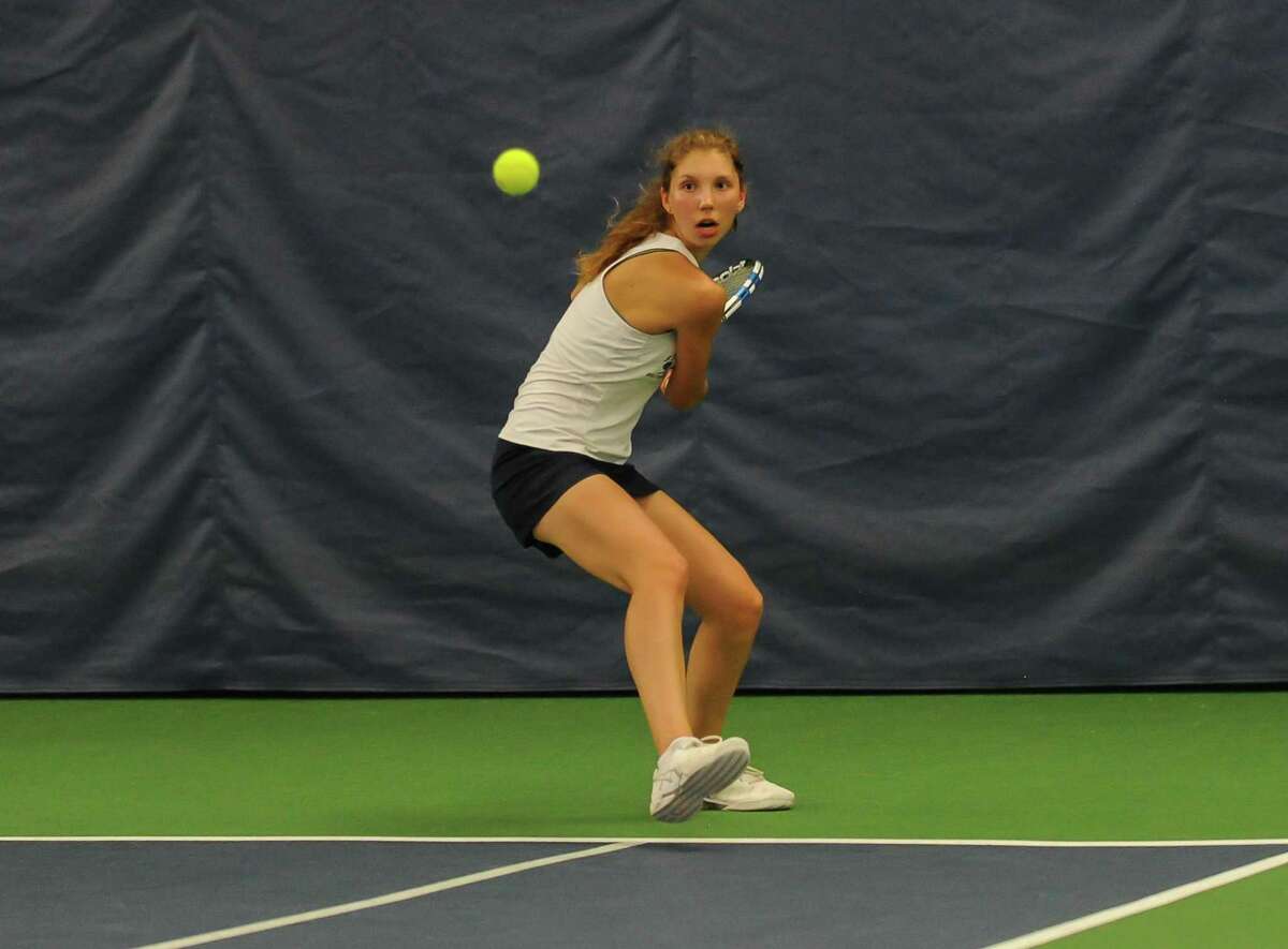 Olivia Foster of the Staples Wreckers hits a backhand return during the CIAC Class L Tennis Championship against the Greenwich Cardinals at the Trumbull Racquet Club on June 3, 2016 in Trumbull, Connecticut.