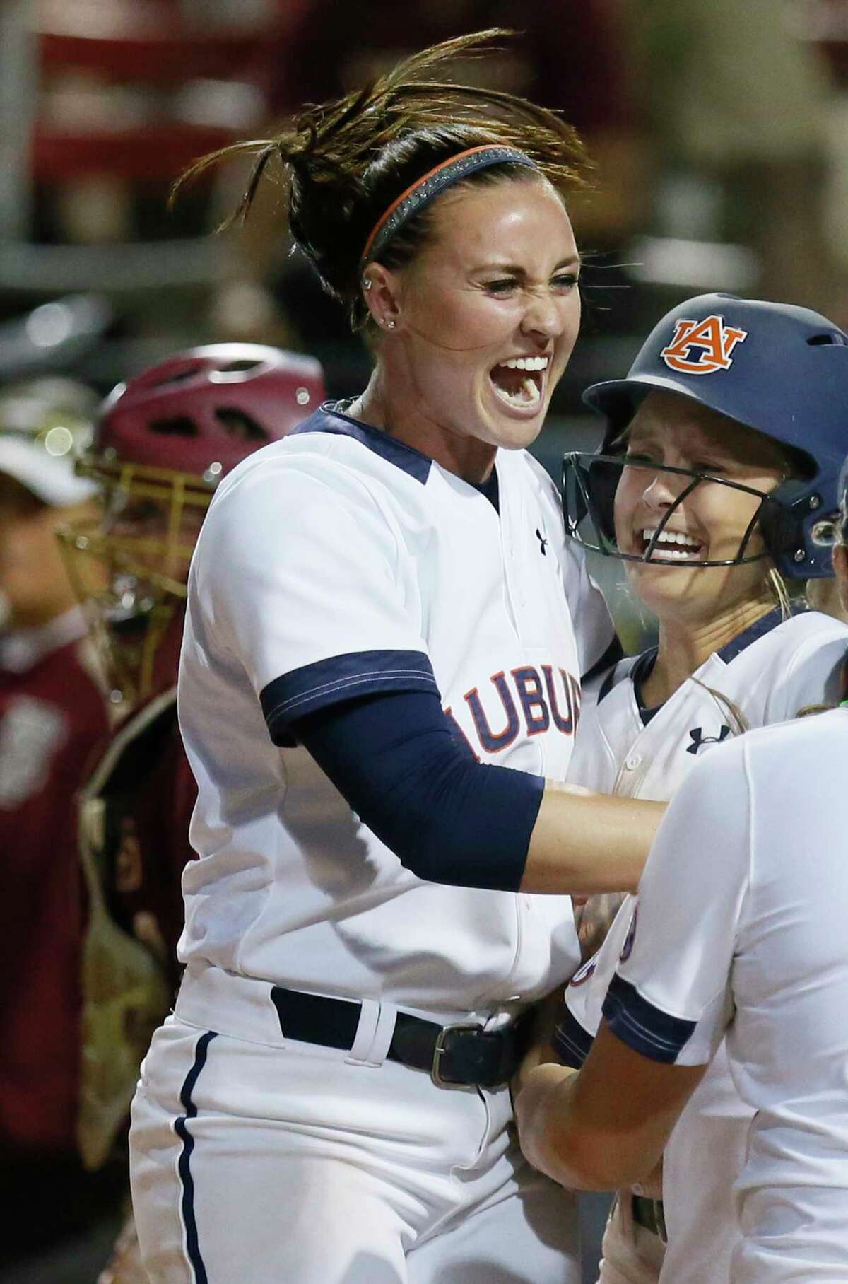 FILE - In this June 5, 2016, file photo, Auburn infielder Haley Fagan, left, and outfielder Morgan Podany celebrate Podany's game winning run against Florida State in the eighth inning of an NCAA Women's College World Series softball game in Oklahoma City. Florida softball coach Tim Walton was involved in an altercation with Auburn shortstop Haley Fagan on Monday night, March 27, 2017, after Walton gave Fagan a slight push during postgame handshakes. (AP Photo/Sue Ogrocki, File)
