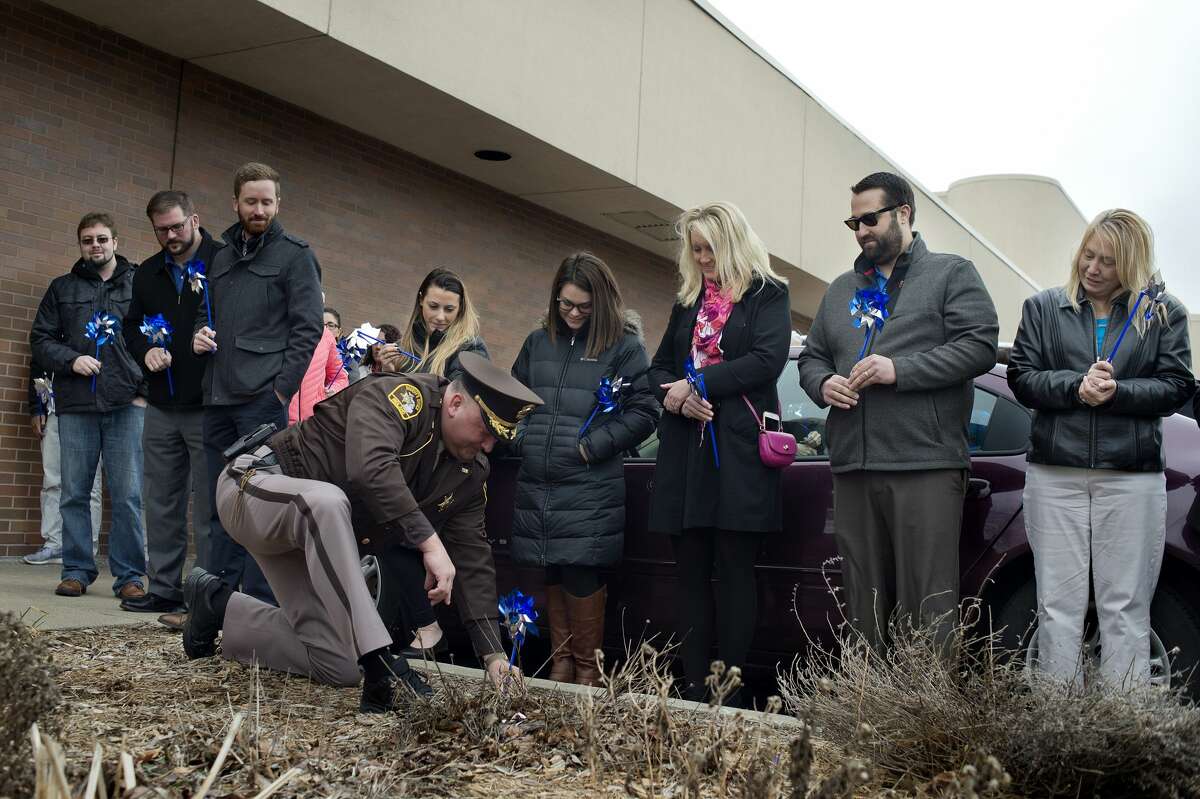 BRITTNEY LOHMILLER | blohmiller@mdn.net Members of the community watch as Sheriff Scott Stephenson plants the first pinwheel in a garden in front of the United Way of Midland County Tuesday afternoon in honor of Child Abuse Prevention Month. In 2016, the Safe & Sound Child Advocacy Center conducted interviews of 140 children who were suspected of being abused or neglected.