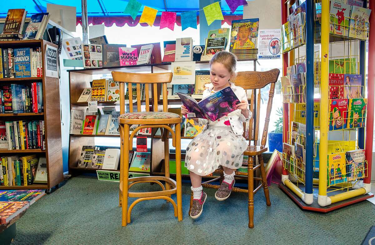 Harper Eastman, age 4, reads from a Disney book she found on the shelves of Hicklebee's Childrens Books in San Jose, Calif. on March 28, 2017. San Jose businesses like Hicklebee's are unsure how the .5% sales tax increase, which goes into effect April 1st, will impact them.