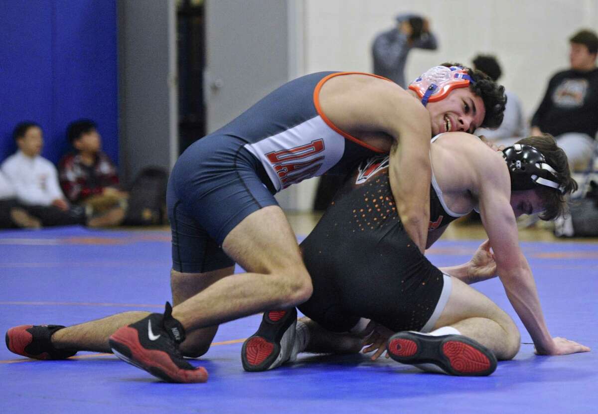 Ridgefield's Peter Murray, right, and Danbury's Kyle Fields, left, wrestle in the 132 pound class during the high school wrestling match between Ridgefield and Danbury high schools, on Wednesday, January 18, 2017, at Danbury High School, in Danbury, Conn.