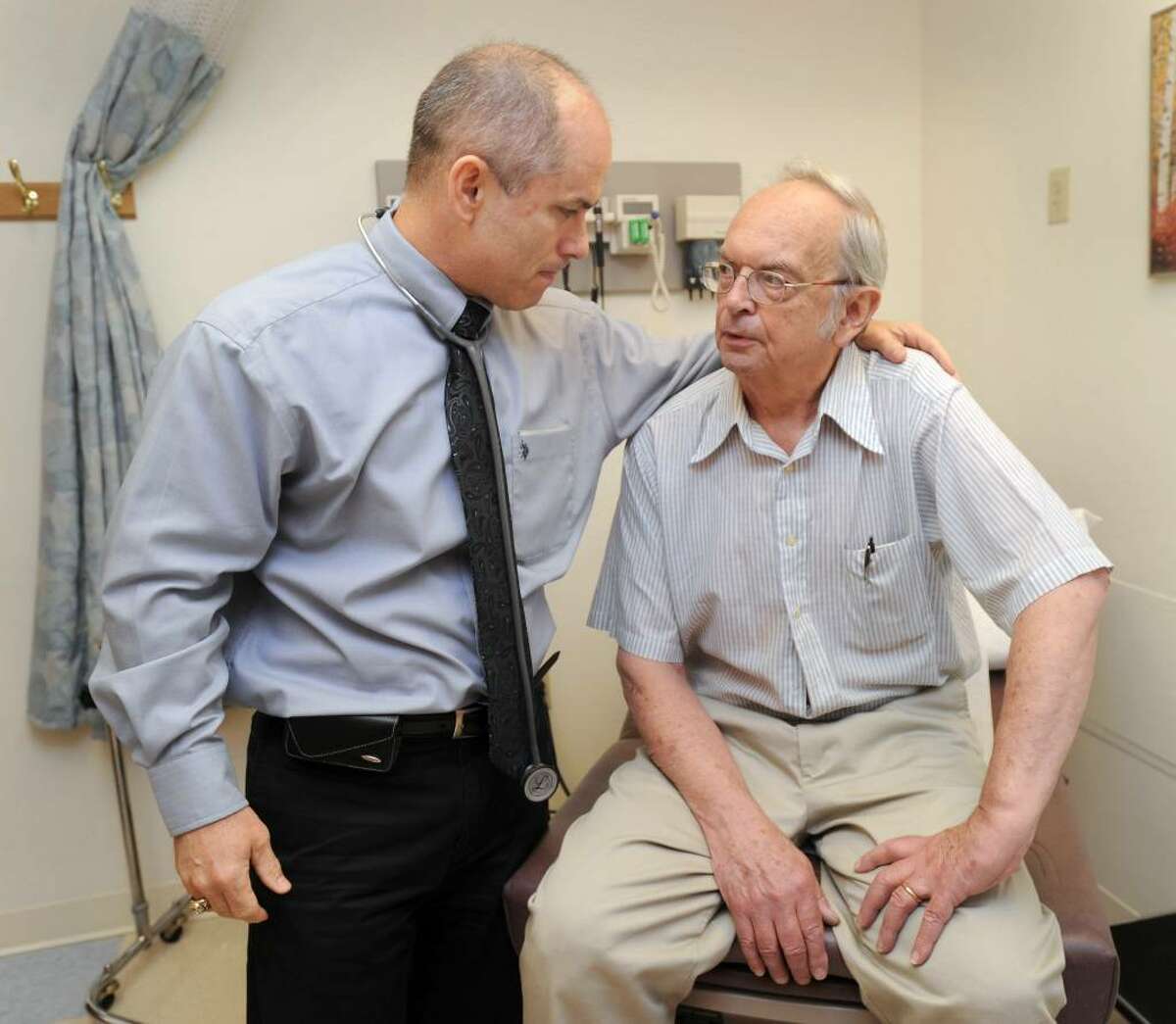 Dr. Casey Ott, left, talks with patient George Cote, 71, of Southbury. Photo taken Tuesday, june 1, 2010.