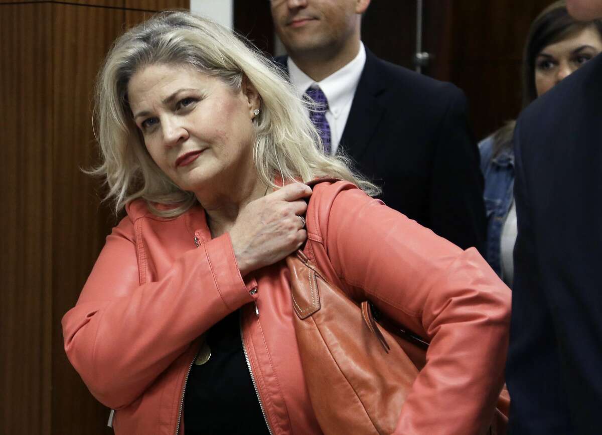 FILE - In this Feb. 3, 2016 file photo, Sandra Merritt, one of the two anti-abortion activists indicted last month, leaves the courtroom after turning herself in to authorities and bonding out in Houston. California prosecutors say two anti-abortion activists who made undercover videos of themselves trying to buy fetal tissue from Planned Parenthood have been charged with 15 felony counts of invasion of privacy. State Attorney General Xavier Becerra announced the charges Tuesday, March 28, 2017, against David Daleiden and Merritt. (AP Photo/Pat Sullivan, File)
