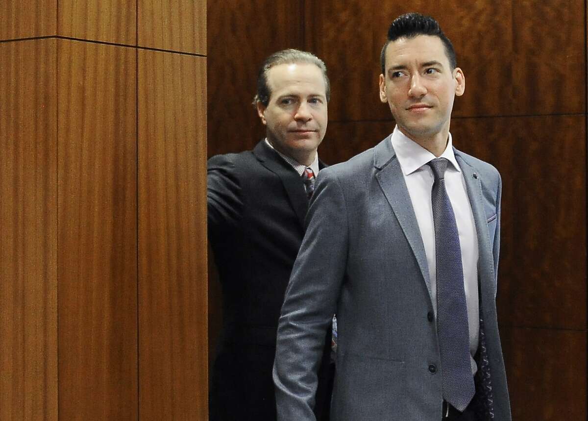 FILE - In this April 29, 2016 file photo, David Robert Daleiden, right, leaves a courtroom after a hearing in Houston. California prosecutors say two anti-abortion activists who made undercover videos of themselves trying to buy fetal tissue from Planned Parenthood have been charged with 15 felony counts of invasion of privacy. State Attorney General Xavier Becerra announced the charges Tuesday, March 28, 2017, against Daleiden and Sandra Merritt. (AP Photo/Pat Sullivan, File)