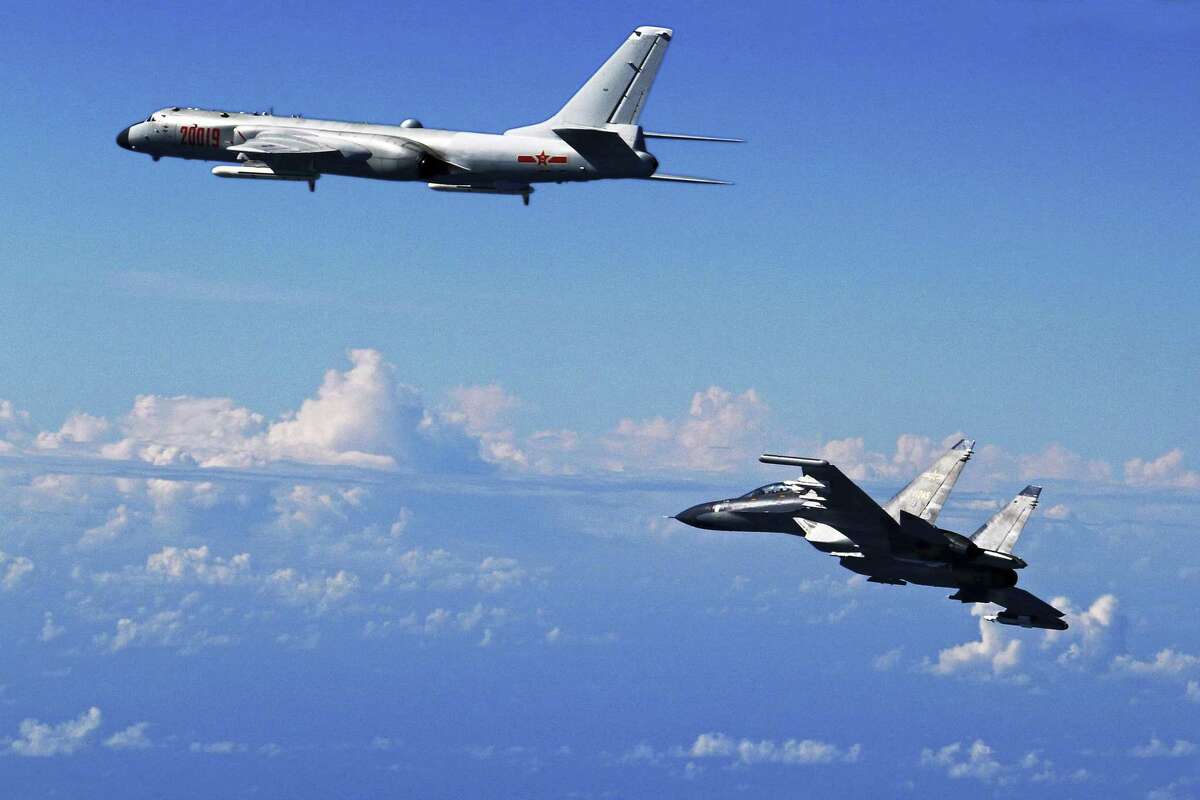 FILE - In this Sept. 25, 2016 file photo released by China's Xinhua News Agency, a Chinese People's Liberation Army Air Force Su-30 fighter, right, flies along with a H-6K bomber as they take part in a drill near the East China Sea. While the U.S. military remains the dominant force in Asia and the world, China has been moving from quantity to quality and is catching up quickly in equipment, organization and capability, and is increasingly able to project power far from its shores. (Shao Jing/Xinhua via AP, File)