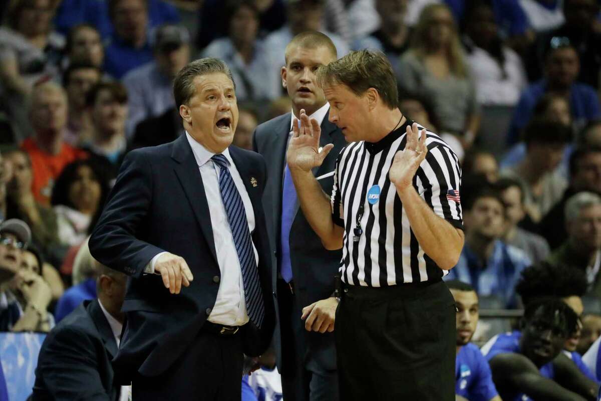 FILE - In this March 26, 2017, file photo, Kentucky head coach John Calipari argues a call with referee John Higgins in the first half of the South Regional final game against North Carolina in the NCAA college basketball tournament in Memphis, Tenn. Referee John Higgins of Omaha has contacted law enforcement to report he’s received death threats after Kentucky’s loss to North Carolina in the NCAA South Regional final. A person with knowledge of the situation told The Associated Press that Higgins reported threats on his home phone, which has an unlisted number, and on the office phone for his roofing company. The person requested anonymity because the investigation is ongoing. (AP Photo/Mark Humphrey, File)