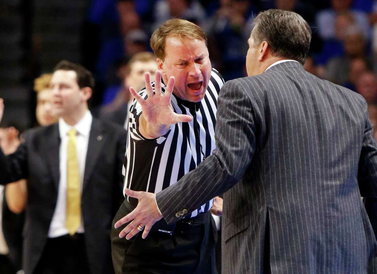 FILE - In this Feb. 28, 2017, file photo, Kentucky head coach John Calipari, right, address official John Higgins after being assessed a technical foul during the second half of an NCAA college basketball game against Vanderbilt, in Lexington, Ky. Referee John Higgins of Omaha has contacted law enforcement to report he’s received death threats after Kentucky’s loss to North Carolina in the NCAA South Regional final.A person with knowledge of the situation told The Associated Press that Higgins reported threats on his home phone, which has an unlisted number, and on the office phone for his roofing company. The person requested anonymity because the investigation is ongoing. (AP Photo/James Crisp, File)