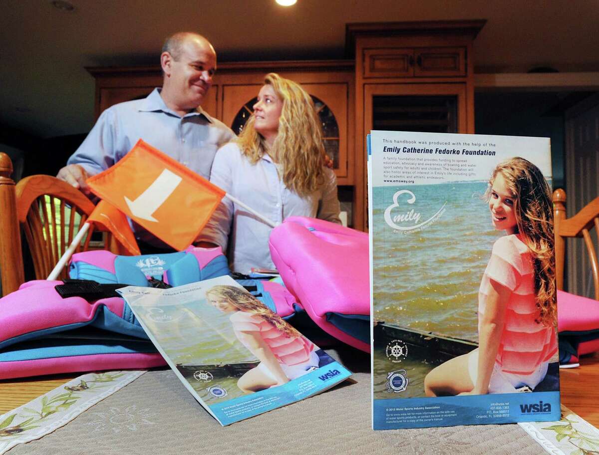 A photo of Emily Fedorko, right, on a boating safety guide is visible as Joe and Pam Fedorko display boating safety items on the kitchen table of their Greenwich home last May. The Fedorkos started the Emily Catherine Fedorko Foundation to honor their daughter, who died in a boating accident at Greenwich Point in 2014.