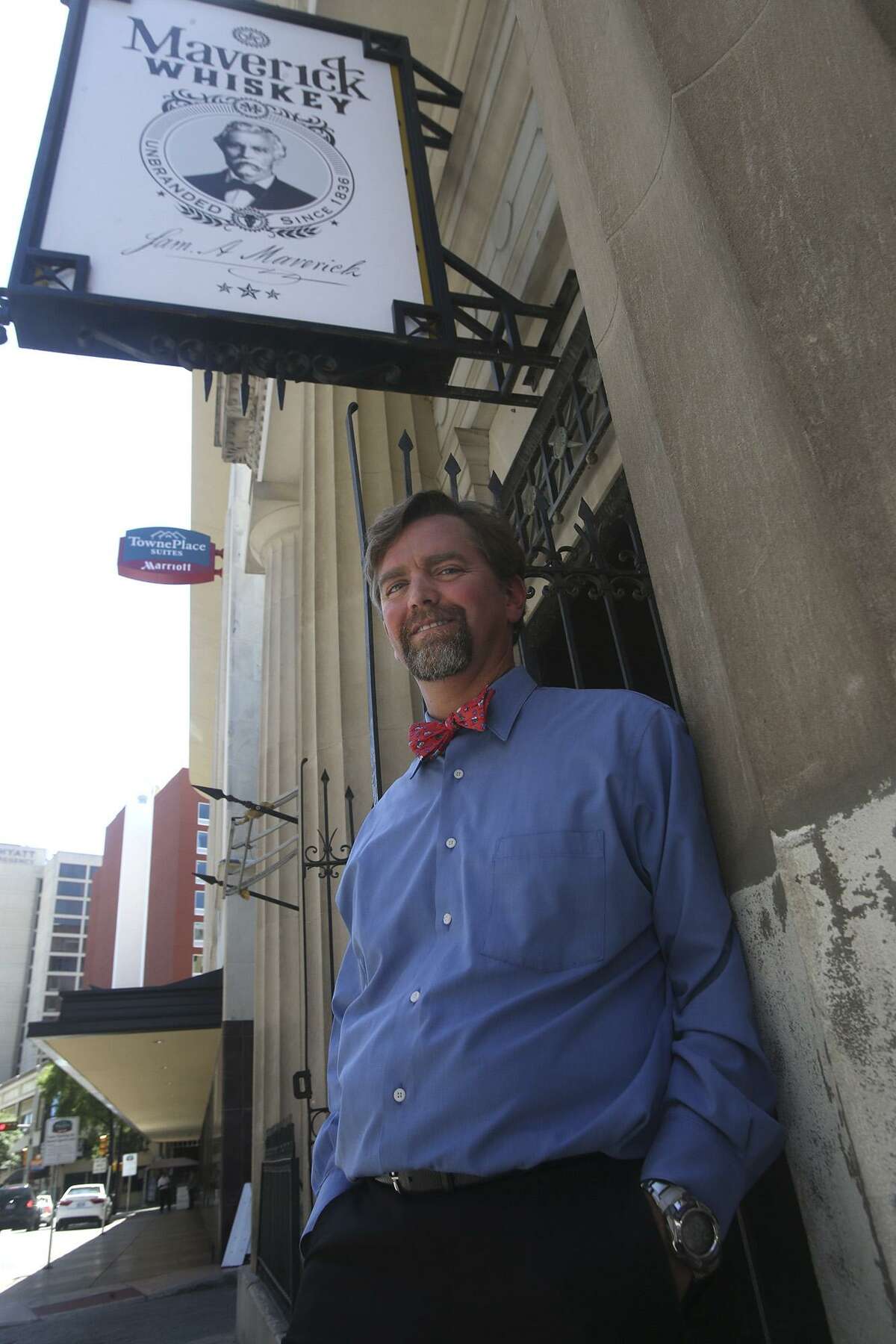 Kenneth Maverick stands in front of the old building in downtown San Antonio at 115 Broadway that he is converting to a microdistillery that will serve whiskey and offer a venue for sipping and swapping stories.
