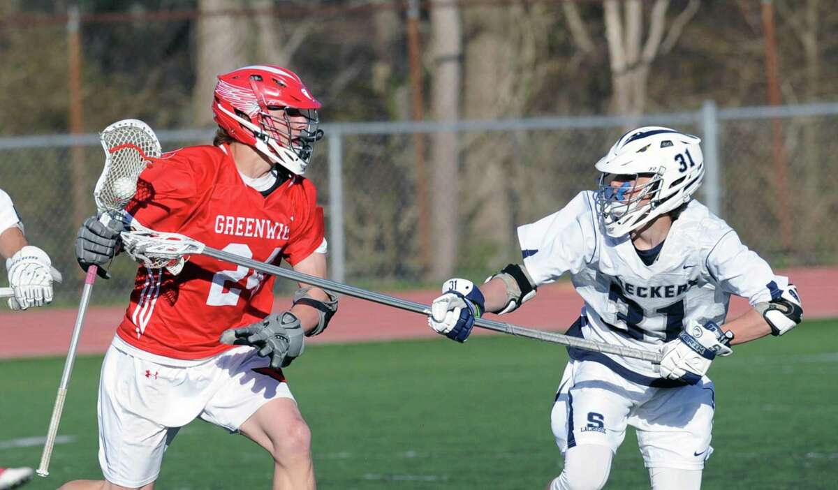 Greenwich midfielder Bailey Savio looks for an opening against Staples’ Bill Hutchison during a game in Westport on April 19, 2016.