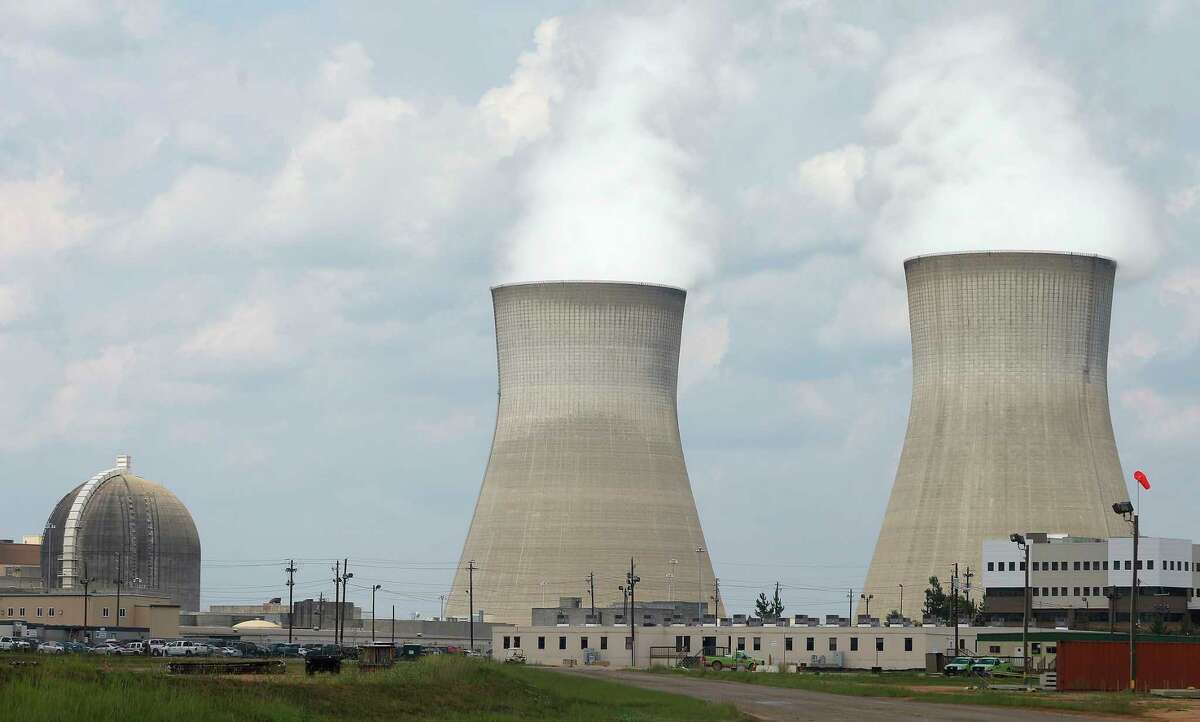FILE - This Friday, June 13, 2014, file photo, shows the cooling towers, right, and nuclear reactor containment buildings area, left, at Plant Vogtle Nuclear Power Plant in Waynesboro, Ga. Westinghouse Electric Co., the U.S. nuclear unit of JapanÂ?’s Toshiba Corp., filed for bankruptcy protection Wednesday, March 29, 2017, calling into question the future of a number of billion-dollar nuclear projects under construction, including two in the U.S. (AP Photo/John Bazemore, File)
