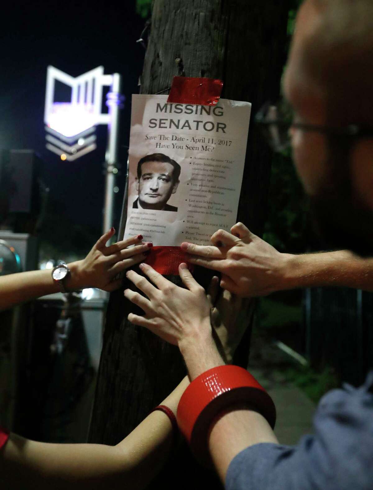 Using signature red duct tape, Houstonians put up "Ted Cruz is missing" fliers up around a Montrose neighborhood, Wednesday, March 29, 2017, in Houston. The fliers are catching people's attention, ahead of an upcoming "Ted Cruz Is Missing" town hall meeting.