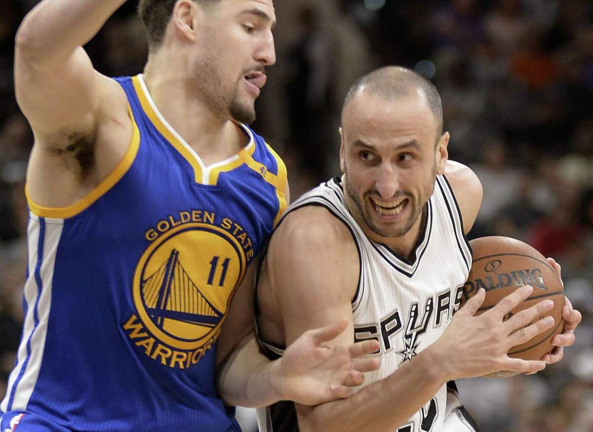 Spurs guard Manu Ginobili drives against Golden State Warriors guard Klay Thompson during the second half on March 29, 2017, in San Antonio. Golden State won 110-98.