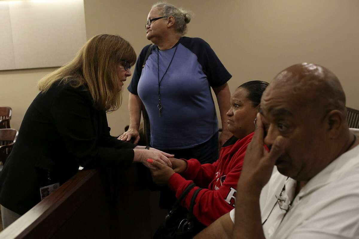 Olivia Fenner, center, the mother of Tru Trusty, who was 16 at the time of his murder on Sept. 26, 2015, talks with prosecutor Catherine Hayes as Fenner's sister, Charlotte, stands by and Trusty's father, Joseph Trusty, right, wipes his tears after Dominique Bailey was sentenced to 30 years in prison after taking a plea deal for murder in the 144th Criminal District Court on Thursday, March 30, 2017.