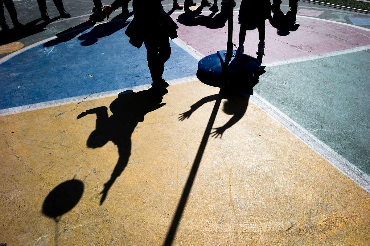 From left: Elger Pinto Guillen, 2nd grade, jumps to hit the ball as he plays with Shanti Dzib Soto, 1st grade, at the Mission Graduates Extended Day Program at Marshall Elementary on Thursday, March 23, 2017, in San Francisco, Calif. Approximately 170 students are part of the after school program there.