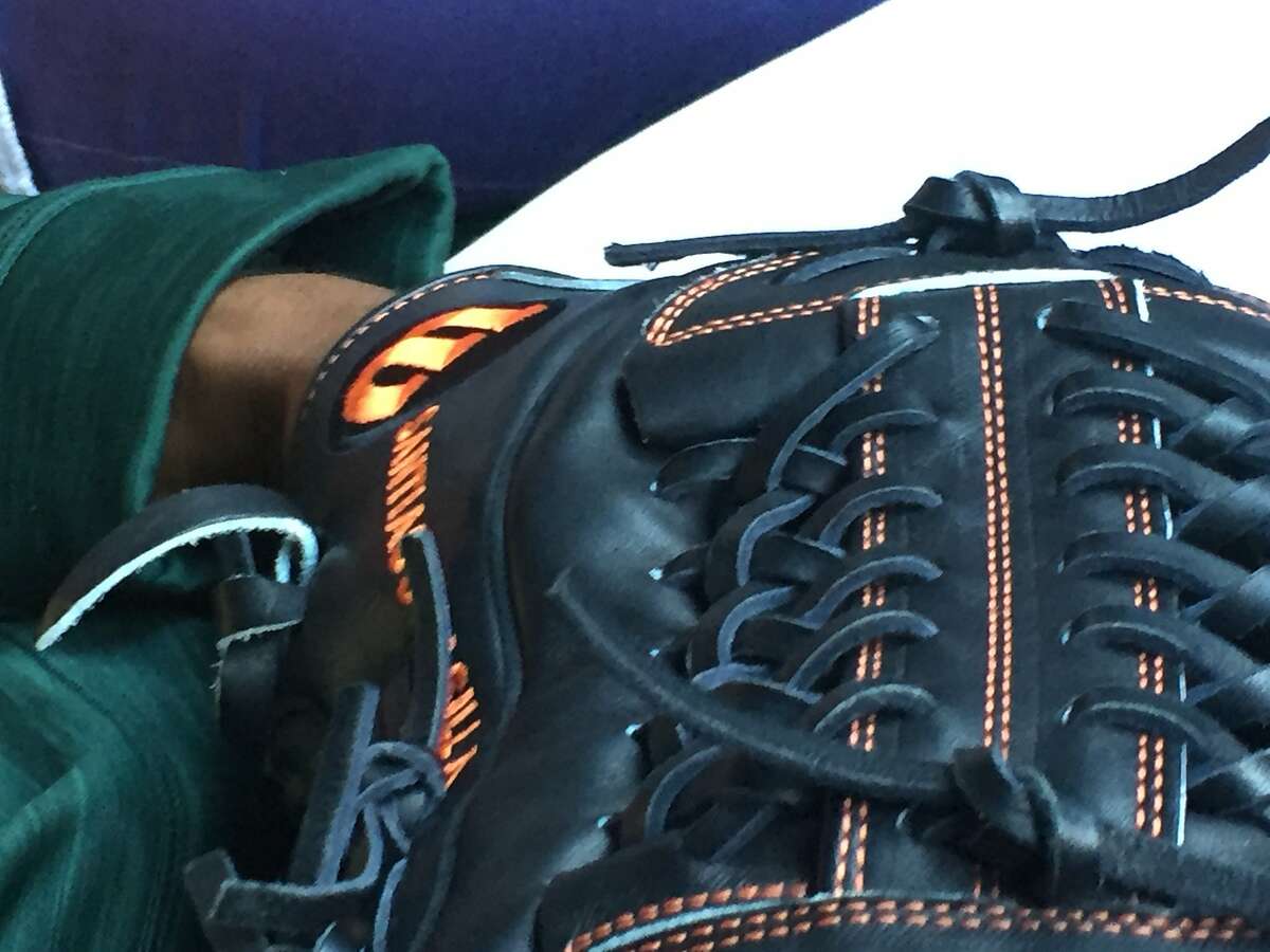 Santiago Casilla's glove. The Oakland Athletics reliever is using the black and orange Wilson A2000 he used in 2016 with the San Francisco Giants. He expects to receive a glove with green lettering soon.� March 30, 2017.