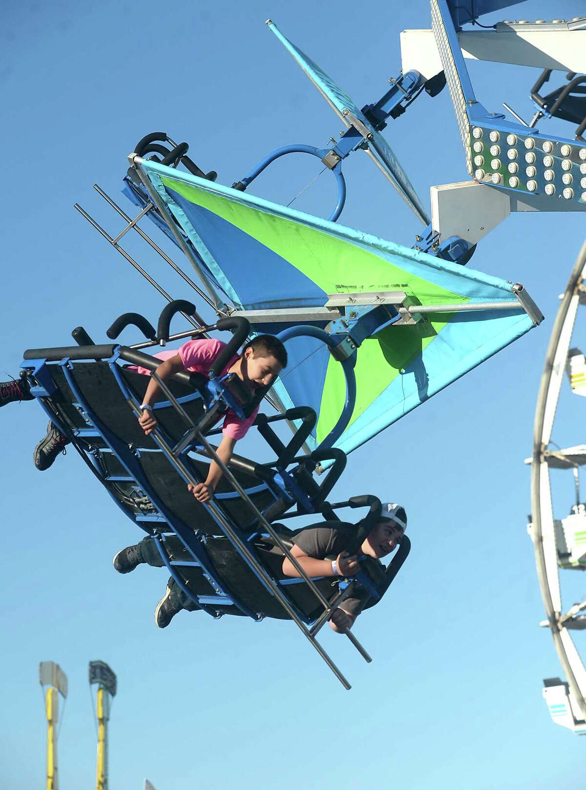 Fair goers get their thrills as they take in the many rides on the midway on the opening night of this year's South Texas State Fair at Ford Park. The YMBL of Beaumont hosted the traditional opening ceremony prior to admission, giving those in attendance free entry. Unlimited air runs ride wristbands were also available Thursday night. The fair runs daily through Sunday, April 9, and features a variety of activities for all ages. This weekend's highlights include the YMBL rodeo, which begins tonight at 7 p.m. For a complete listing of events and times, go to www.ymbl.org Photo taken Thursday, March 30, 2017 Kim Brent/The Enterprise