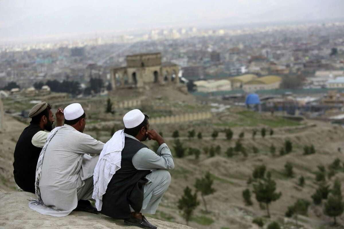 In this March 27, 2017, file photo, men sit on the Nadir Khan hilltop overlooking Kabul, Afghanistan. As America?’s 16-year war in Afghanistan drags on, Russia is resurrecting its own interest in the ?“graveyard of empires.?” The jockeying includes engaging the Taliban and leading a new diplomatic effort to tackle Afghanistan?’s future, all while Washington leaves the world guessing on its strategy for ending the conflict. (AP Photo/Rahmat Gul)