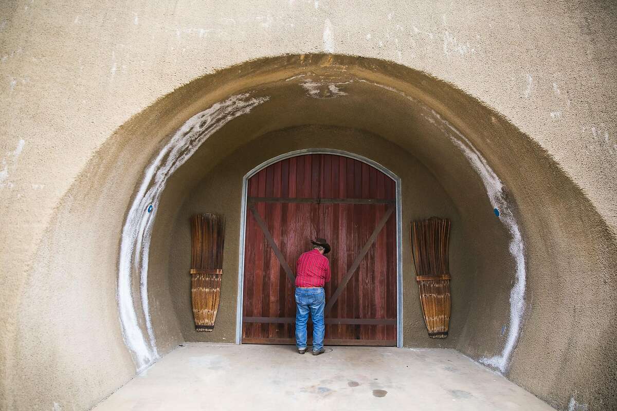 Ranch Assistant Jack Saylor checks on the door of the wine cave at Six Sigma Ranch & Winery in Lower Lake.