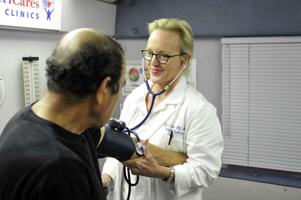 Dr. Katy Close administers a checkup in December 2015 at a free clinic in Stamford, Conn. sponsored by AmeriCares. That year in Fairfield County, an additional 10,000 people secured health insurance according to new estimates released in March 2017 by the U.S. Census Bureau, lowering the rate of people lacking insurance locally to 9.2 percent of the population.