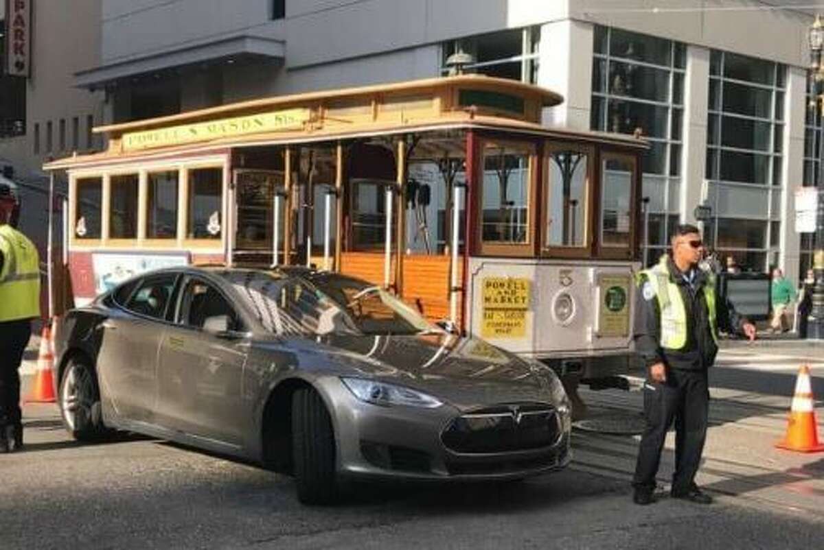 It wasn’t immediately clear who was at fault, the gripman of the iconic cable car or the driver of state-of-the-art electric Tesla.