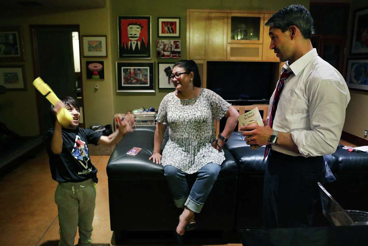 Ron Nirenberg, right, District 8 Councilman who is running for Mayor of San Antonio listens to his son Jonah, 8, tell about his new Karate belt with his wife Erika, center, after a full day of meetings and campaigning on Wednesday, March 29, 2017.