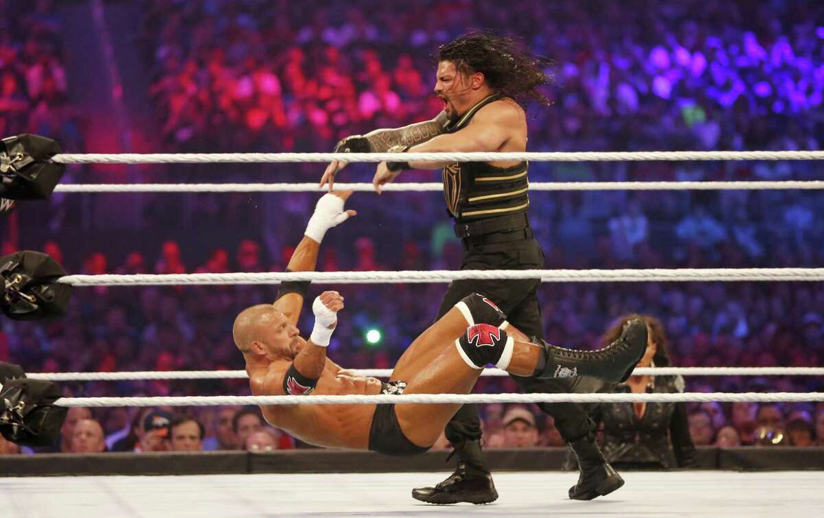 Roman Reigns, right, wrestles Triple H during WrestleMania 32 at AT&T Stadium in Arlington, Texas, Sunday, April 3, 2016. (Jae S. Lee/The Dallas Morning News via AP)
